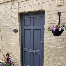 Photograph of the front door of Number 2. Our first floor apartment is in the oldest and most quirky part of our property.